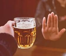 rejecting a mug of alcohol